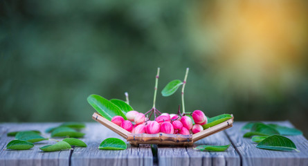 Bengal-Currants Laying on the floor, on a natural background.Bengal-Currants, fermented water in jars, for refreshing drinks