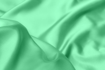 green satin fabric texture soft blur background