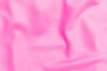 Plastic pink satin fabric texture soft blur background