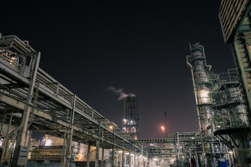 Pipeline and pipe rack of petroleum industrial plant at night