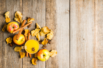 Autumn hot and spicy drink with pumpkin and orange juice on the rustic background. Selective focus. Shallow depth of field.