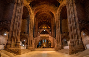 LIVERPOOL, ENGLAND, DECEMBER 27, 2018: Panoramic view of the magnificent huge entrance hall of the Church of England Anglican Cathedral of the Diocese of Liverpool. - obrazy, fototapety, plakaty