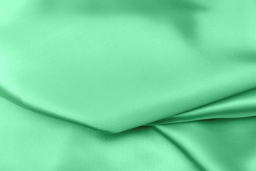 green satin fabric texture soft blur background