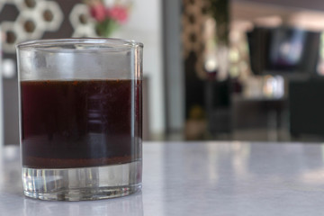 old fashioned glass of black coffee in the hotel and cafe in the afternoon and evening - segelas kopi hitam  di hotel dan cafe pada sore dan malam hari