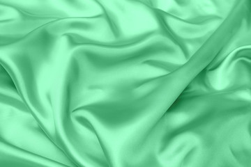 green satin fabric texture soft blur background