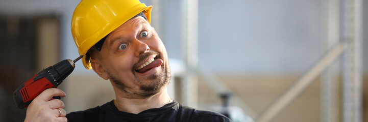 Idiot worker using electric drill portrait