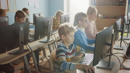 Elementary School Computer Science Classroom: Diverse Group of Little Smart Schoolchildren using Personal Computers, Learn Informatics, Internet Safety, Programming Language for Software Coding - Powered by Adobe