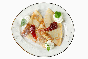 Pancakes with syrup and ice cream on a plate. Appetizing dessert. Top view. Isolated over white background.