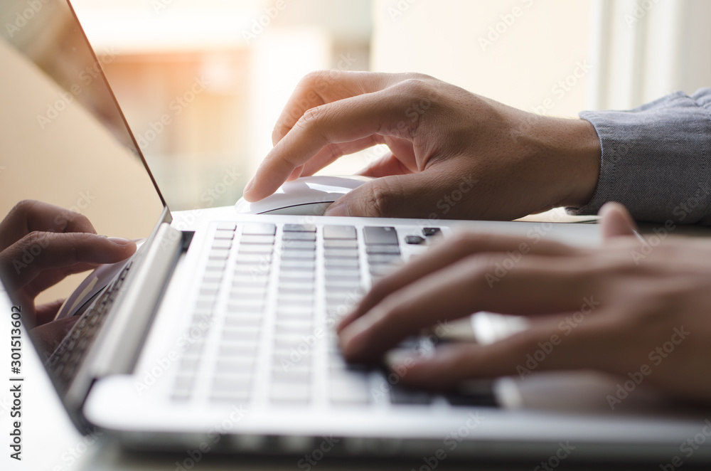 Poster man using wireless mouse on laptop computer