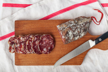 pork dry sausage on wooden board