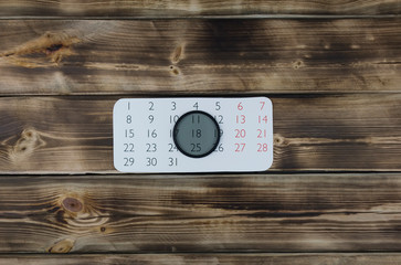 Calendar and grey filter on wood