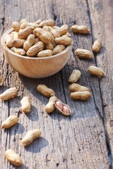 Peanut, snack, in wood bowl on classic wooden table background