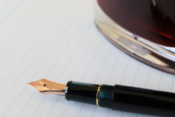 note and fountain pen on table