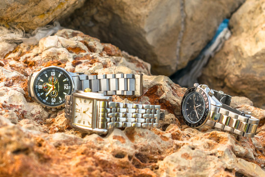 an exotic and luxury stainless silver big dial man's watches kept on brownish rocks