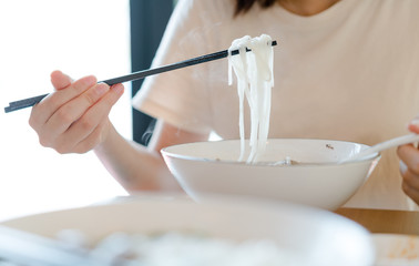 Asian woman washing hands  in a sink