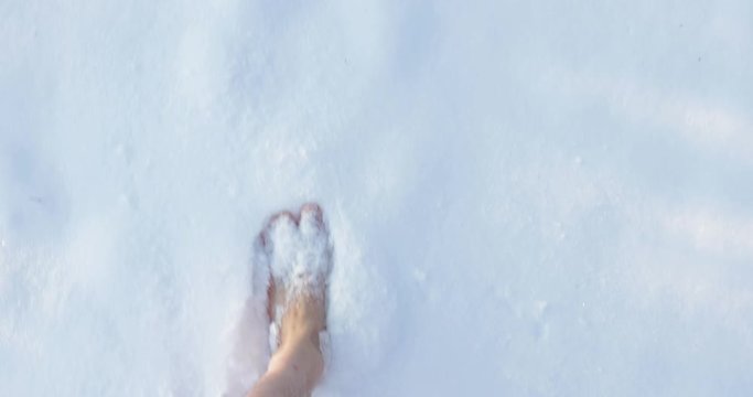 Walking barefoot in snow, first person point of view