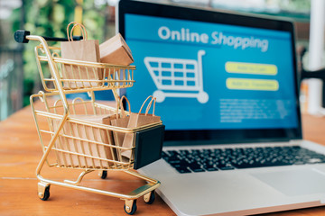 Online shopping and iot(internet of things) concept.Boxes in a trolley on a laptop. Ideas for online shopping,online shopping is consumers to directly buy goods from a seller over the internet.