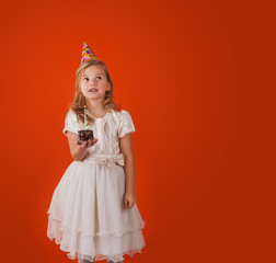 little girl blows out the candles on the holiday cake. birthday party