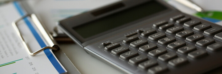 Silver calculator with gray keyboard is lying