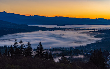 Tos of high rise condos just peeking through cloud inversion over Port Moody at sunrise
