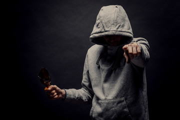 The silhouette of a man in the hood on a black background