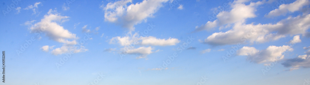 Wall mural panoramic view of blue summer sky with white clouds or cloudscape.