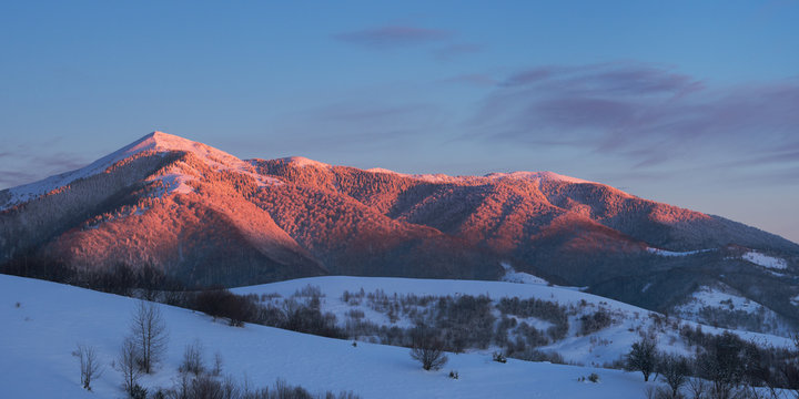 Panoramic view of winter mountain at sunset