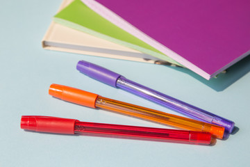 Office supplies or stationery. Multi-colored pens and notebooks