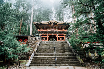 Taiyuin shirne at Nikko world heritage site in Japan in autumn rain with forrest background.