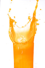 Fototapeta na wymiar orange juice splash in a glass isolated on white background