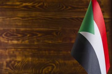 Fragment of the flag of the Republic of Sudan in the foreground space for text blurred background