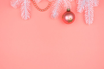 White Christmas tree branches, pink ball and pearls.
