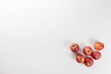Naklejka na ściany i meble Red ripe apples on white background. Vegetarian food concept. Top view.