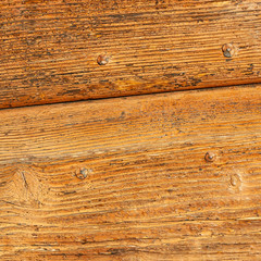 Obraz premium Wooden panels of rural house door, Italy. Textures in wood painted with traditional colors of country houses, cracked and ruined by time.