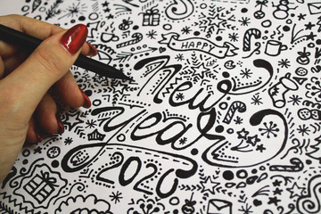 hand drawing happy new year 2020 merry christmas art black and white painting doddle design details on the paper hand drawn red nails cartoon sketch elements gift card girl holding pencil people