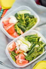 Close-up of containers with vegetables in nature during a picnic, close-up. Summer, rest, healthy eating concept