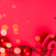 Frame from decorations, bokeh lights on red background. Merry Christmas, New Year, Valentine, invitation concept. Top view, copy space, flat lay, square format