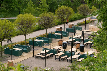 Fototapeta premium Wooden stylish pub located on public park, among greenery.