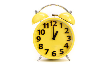 Yellow alarm clock on white at 1 o'clock