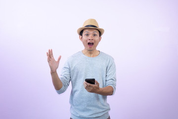 Happy  asian  man  shopping  with smart  phone  on  pink  background.