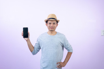 Happy  asian  man  shopping  with smart  phone  on  pink  background.