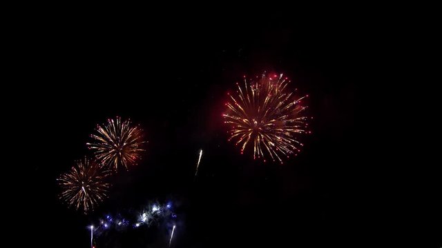 4K Beautiful colorful holiday fireworks on the black sky background