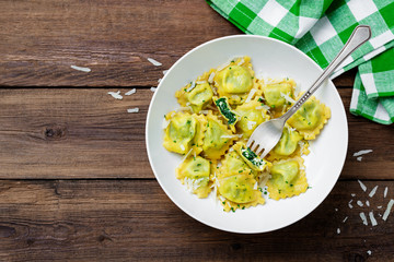 Italian ravioli pasta with spinach and ricotta on  wooden  background. Top view.