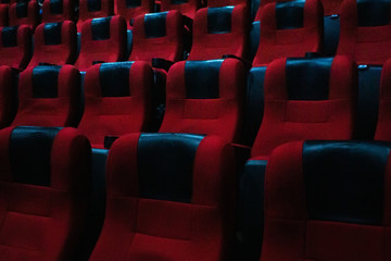 Obraz premium empty seats in the cinema hall. Rows of traditional red covered chairs, movie theater.