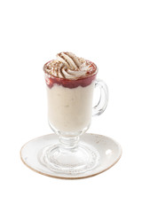 Delicious vanilla milkshake with strawberry topping and whipped cream in tall glass isolated on white background