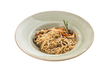 Noodles with beef, vegetables and sesame seeds on grey plate isolated on white background