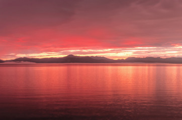Fototapeta na wymiar Rainy jrange red flamy sunset at Houbsougoul lake
