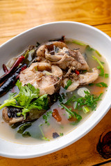 Tom Yum Snakehead Fish,Tom Yum Snakehead fish on Thai tableware In a bowl on a white ground for design in Thai food concept