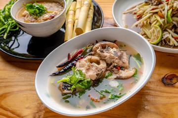 Tom Yum Snakehead Fish,Tom Yum Snakehead fish on Thai tableware In a bowl on a white ground for design in Thai food concept