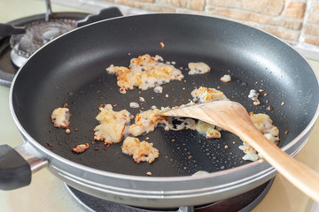 Chopped diced raw garlic in a stir frying pan with oil